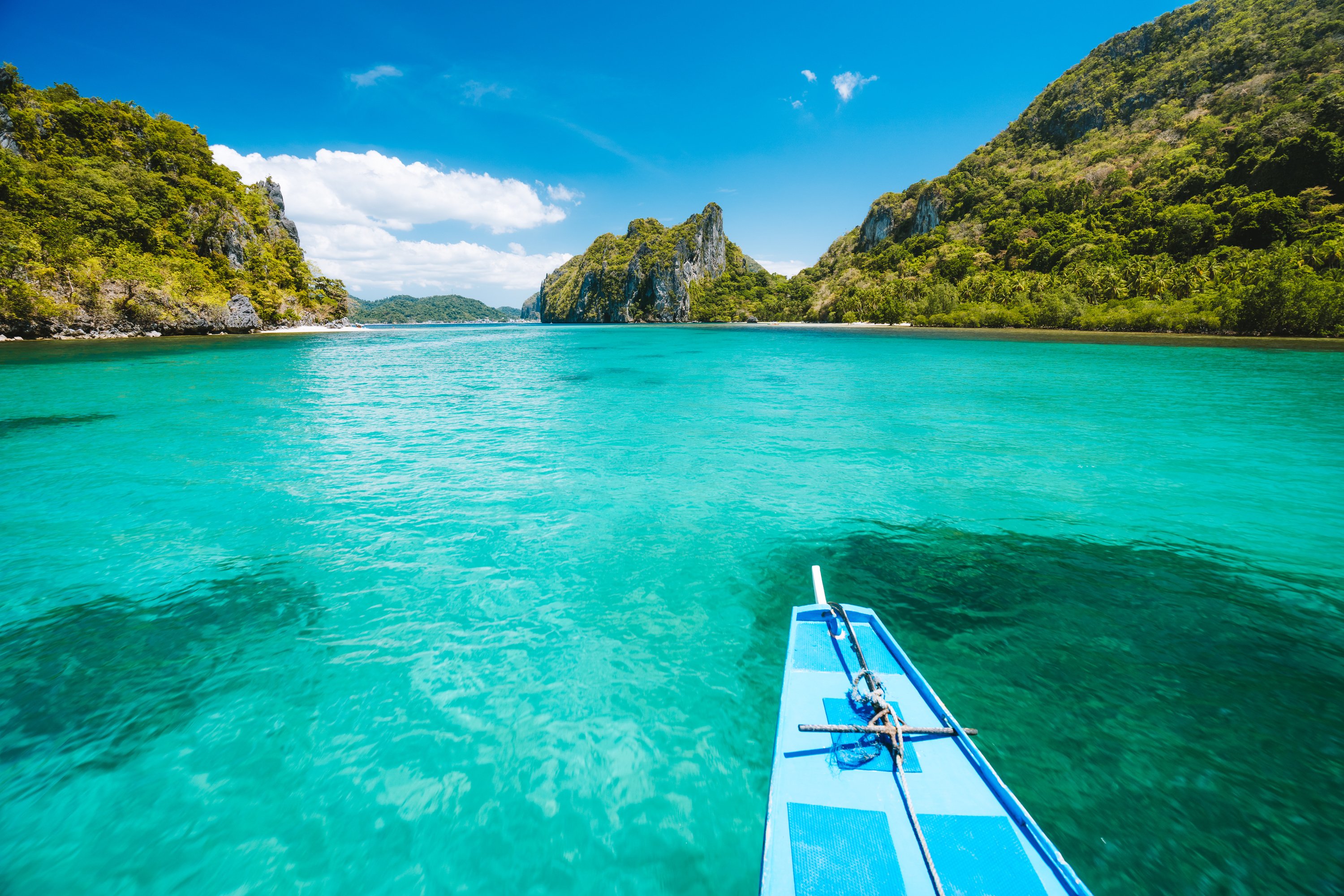 Trip tourist boat in blue shallow water lagoon. Discover exploring unique nature, journey to paradise approaching tropical island